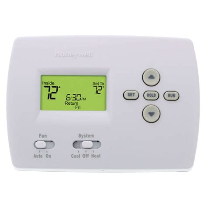 How does a programmable thermostat save energy?